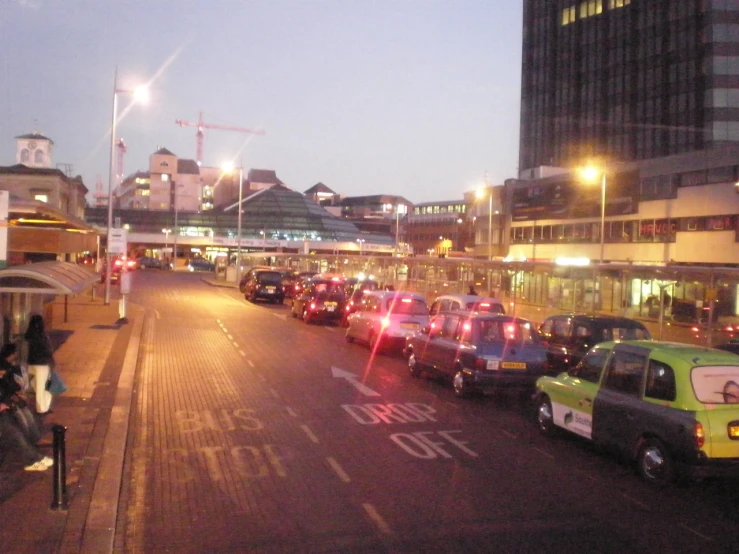 many vehicles parked on the side of the street