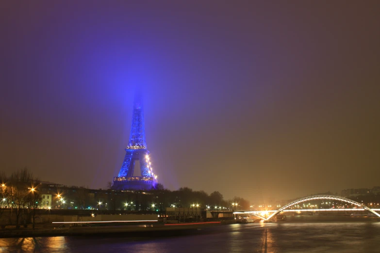 the eiffel tower lit up at night