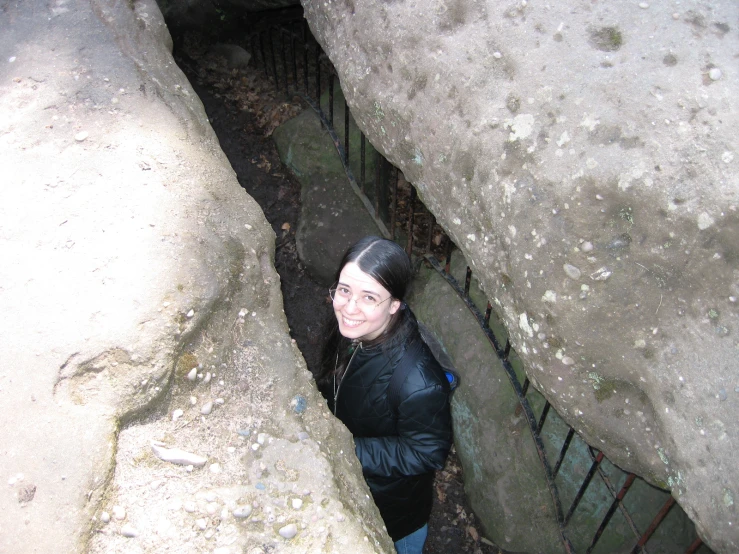 the young person is standing in an entrance to a small pit