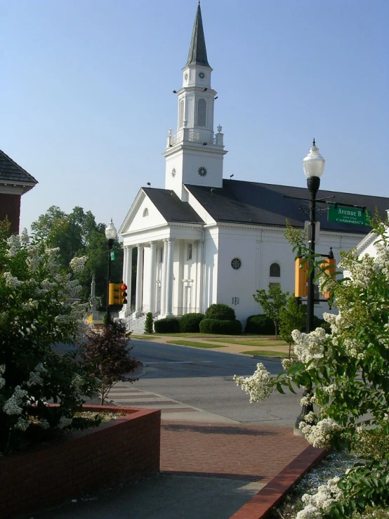 a white church with a steeple and clock tower on it