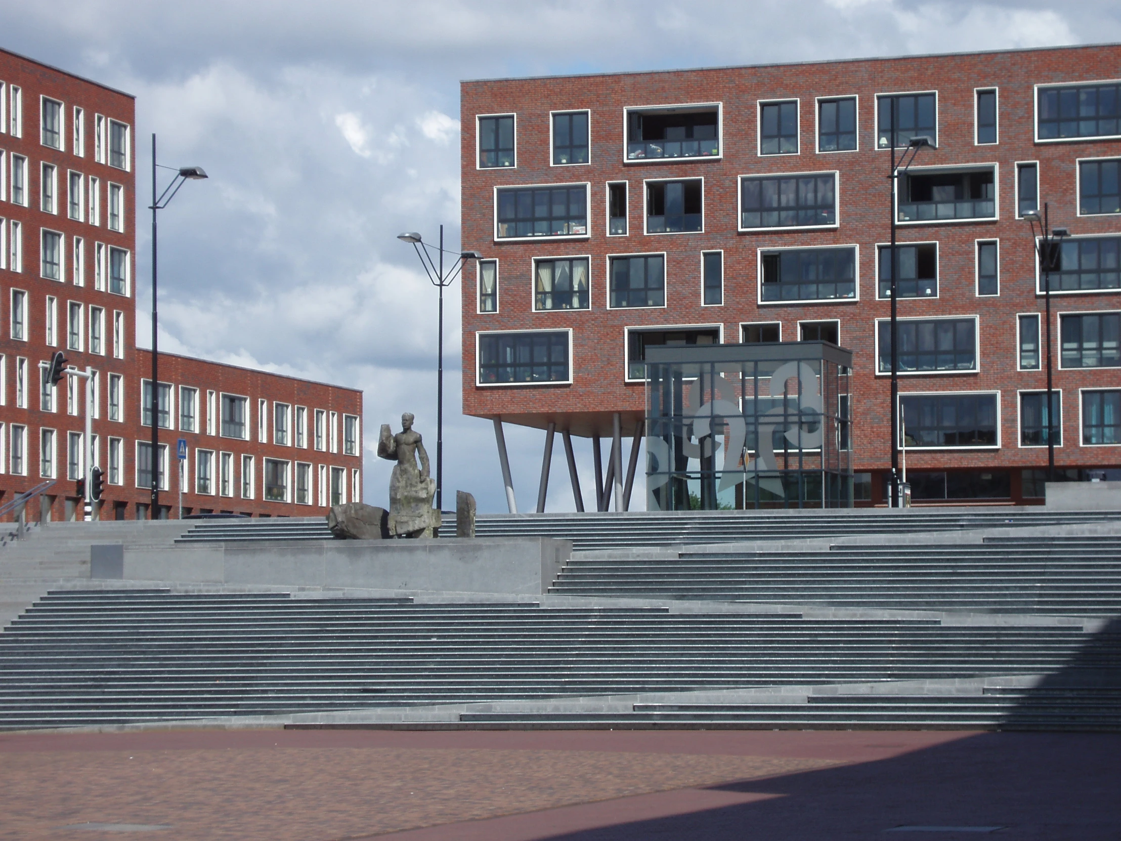 a statue is on some steps outside of an office building