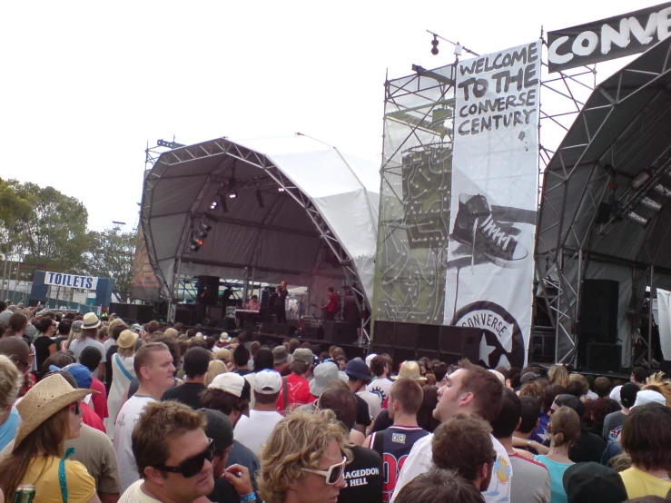 people are gathered at an outdoor concert