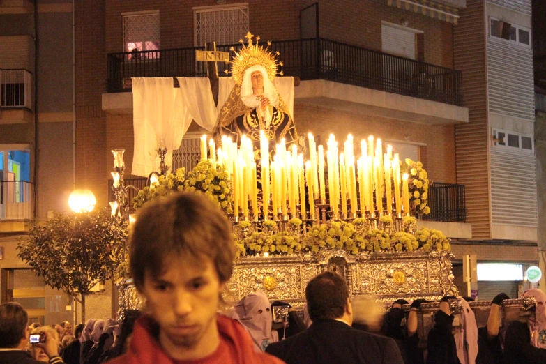 a large shrine is lit with white candles