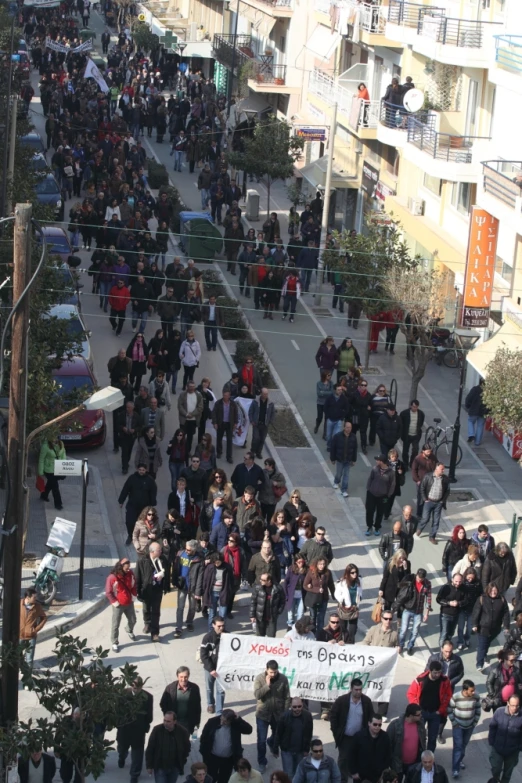 large crowd of people walking down a street