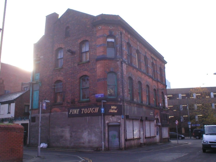 a very old looking brick building with many windows