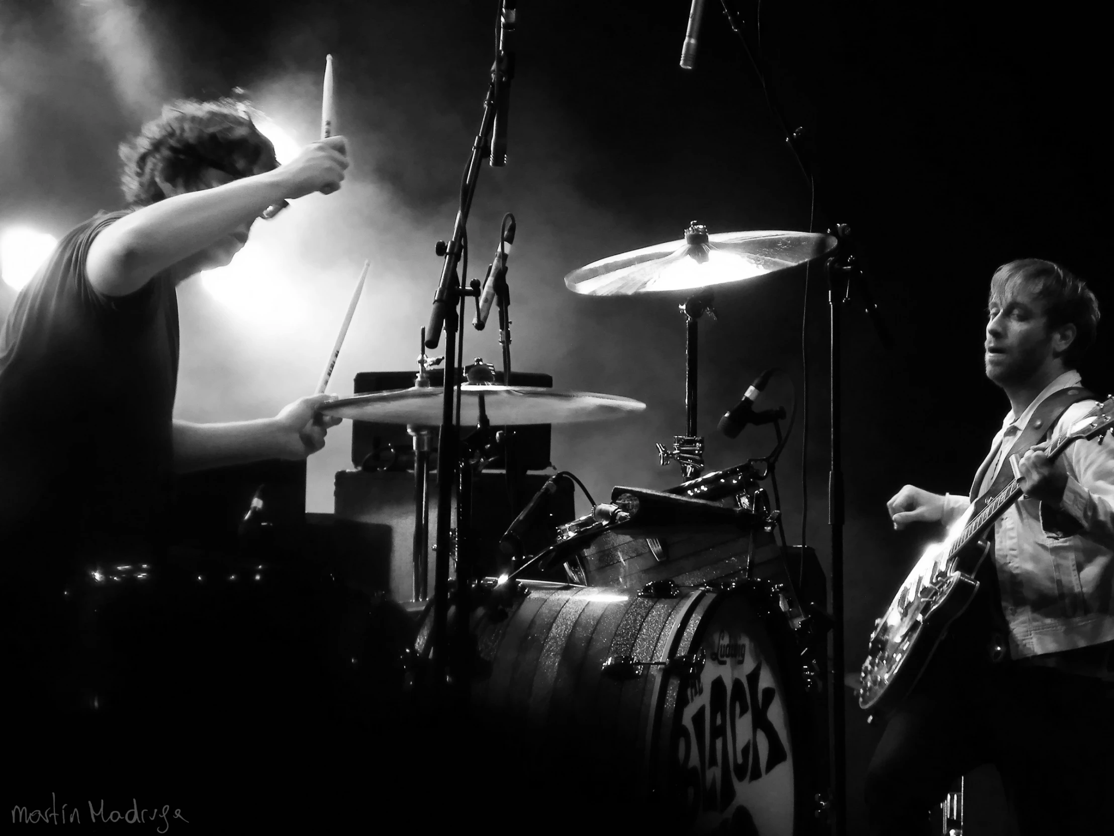 two people play the drums on stage