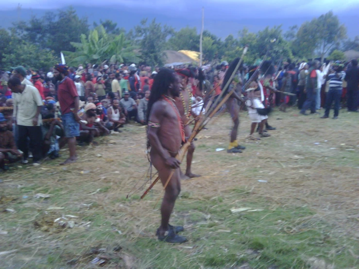 several men in native american attire standing in a field