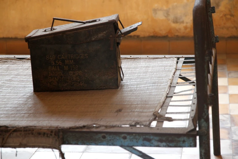 a piece of luggage sitting on top of a metal bench