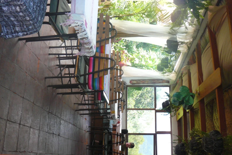 a restaurant with long tables and chairs and windows