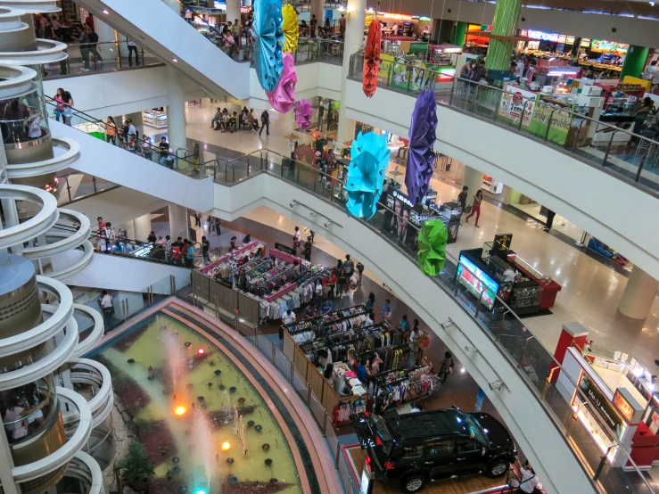 a large and crowded shopping mall with many different vehicles