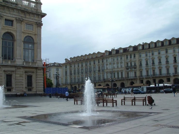 the fountain is situated in front of the building