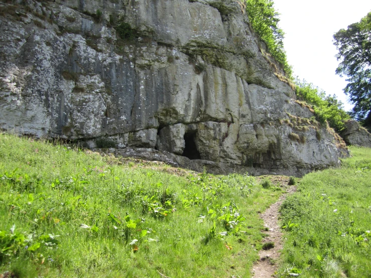 a hiker descends into a narrow ravine near the rocks
