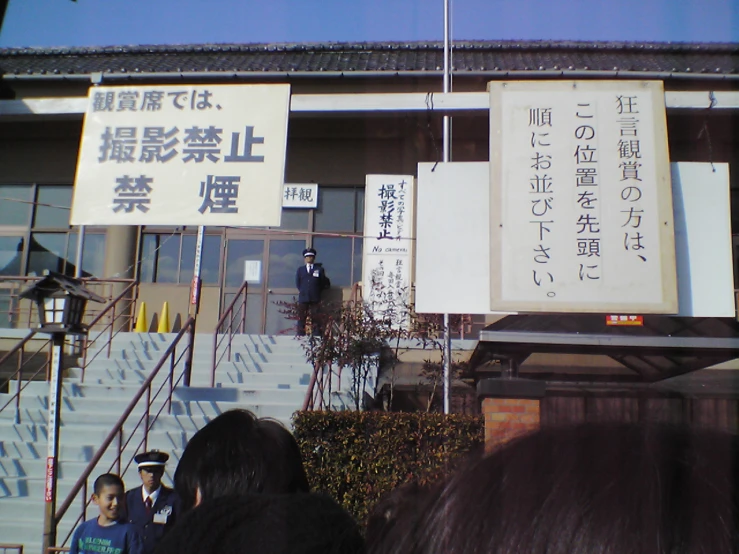 some asian signage outside of a building with a blue sky in the background