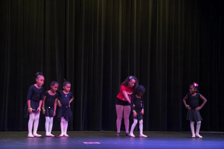 a group of s standing on top of a stage