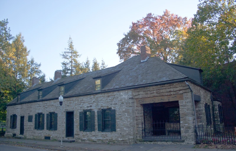 the stone and glass house has an arched doorway