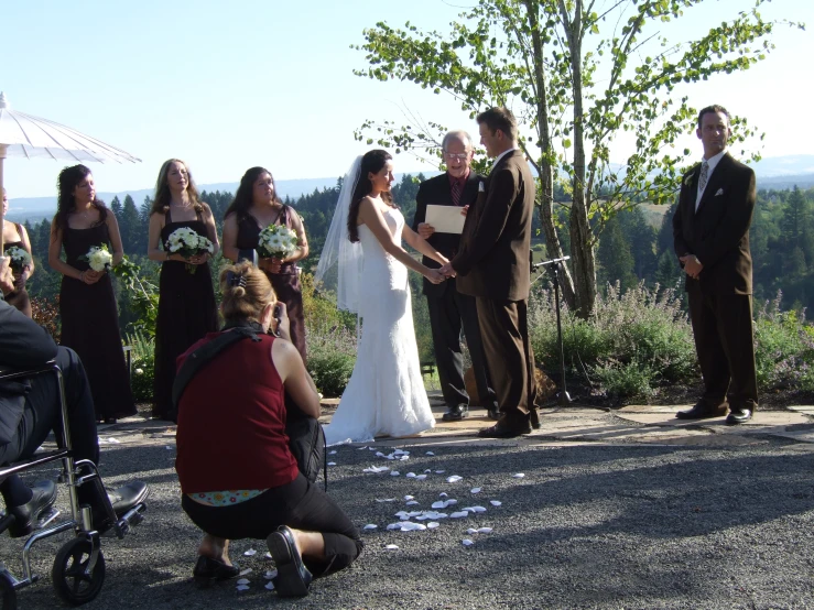 wedding ceremony with a bride and groom on top of a mountain