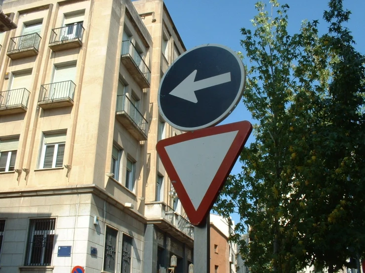 a street sign at an intersection next to a building