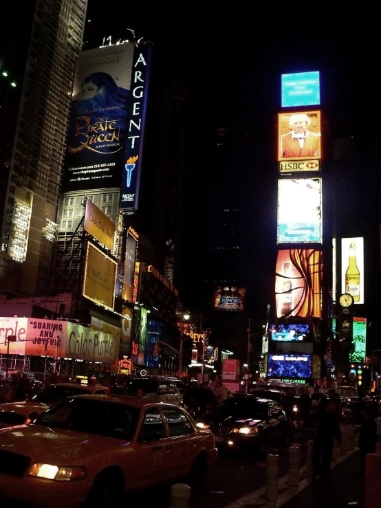 a busy city street with tall buildings and cars on the street