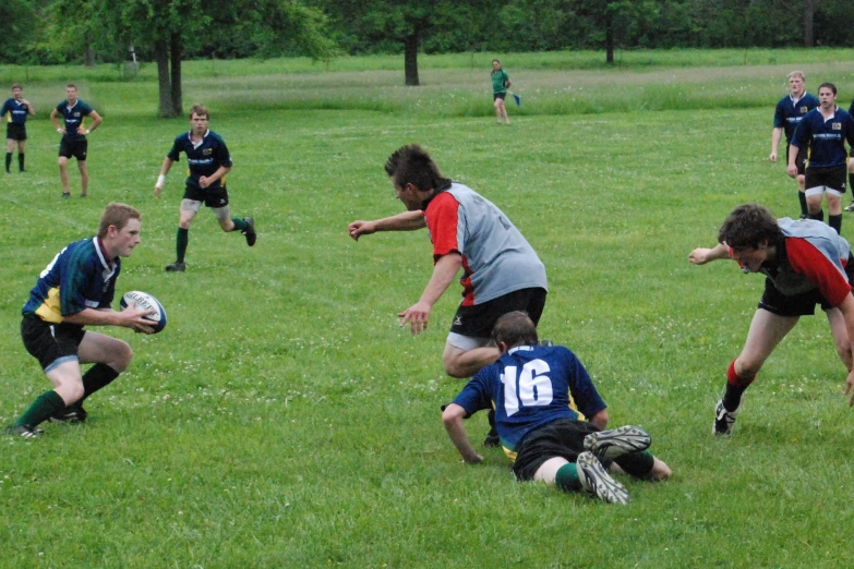 some people playing soccer and some people running in the grass