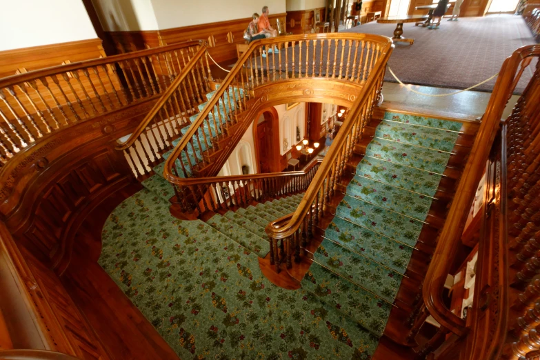 several people are gathered around in an ornate room