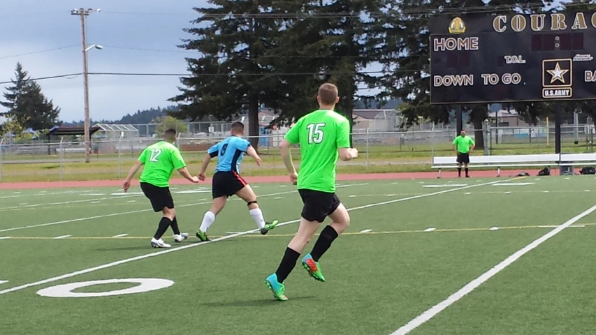 a group of boys playing soccer on a field