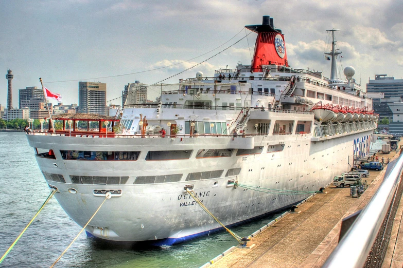 the large boat has people on it's deck