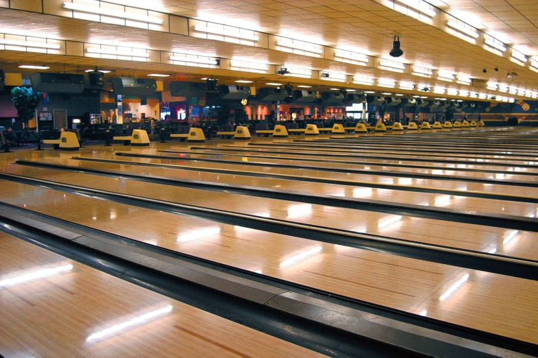 there is an empty bowling alley with many rows