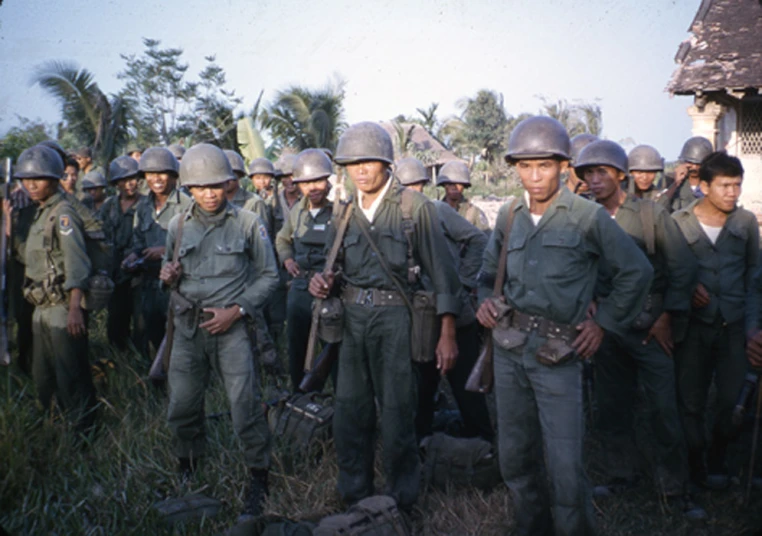 many military soldiers in uniform standing around each other