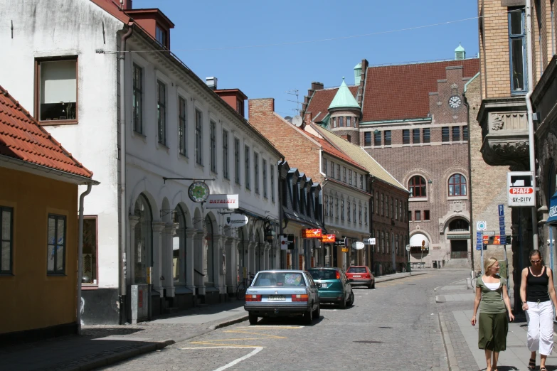 there is a group of people walking in the city street