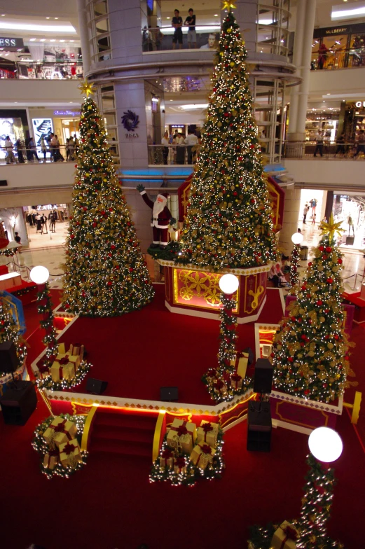 the large christmas trees are on display inside a shopping mall