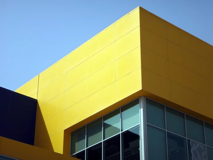 a window and side of a yellow building