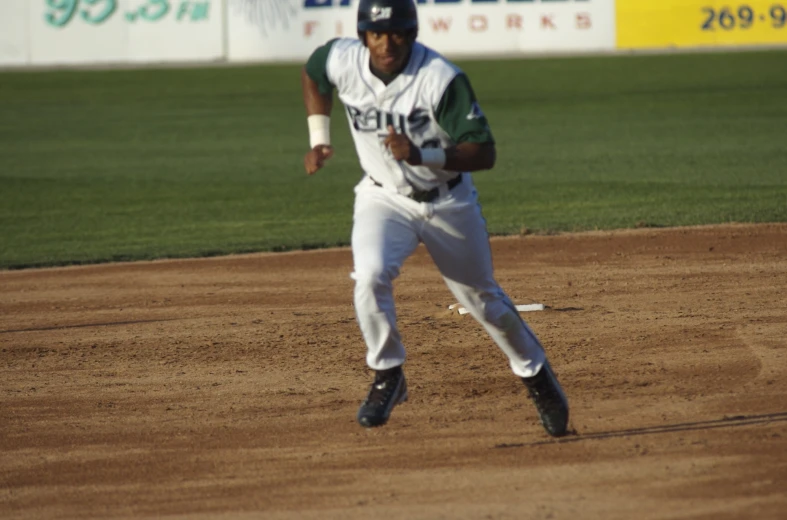 a man running on a baseball field with a glove