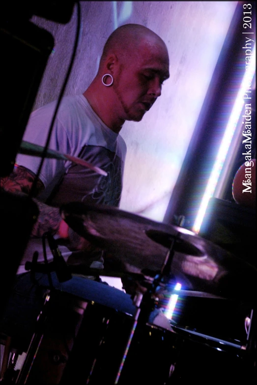 a drummer playing drums in the dark