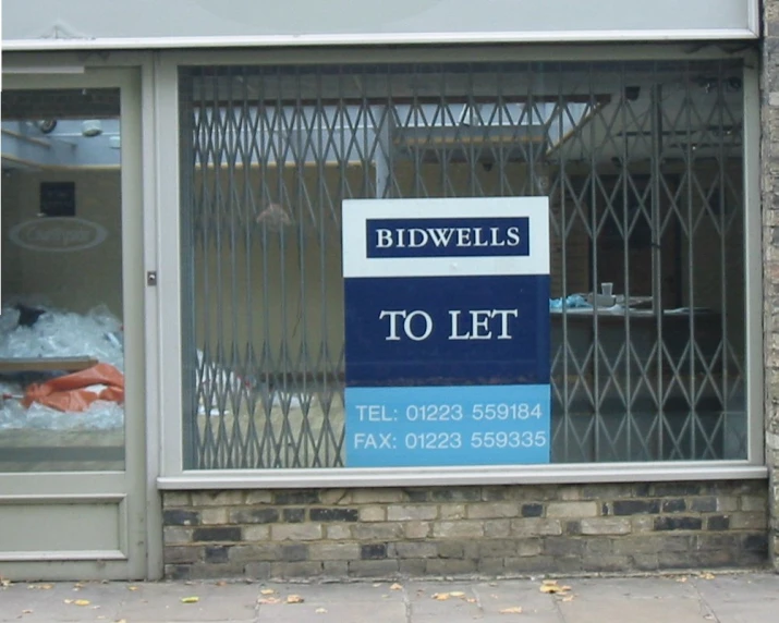 a storefront with signage in front of it