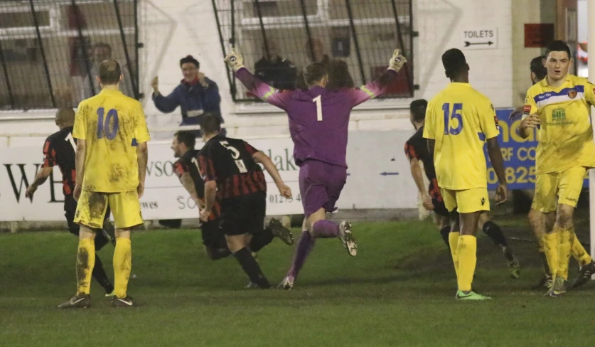 a soccer player getting mobs of joy at the end of the game