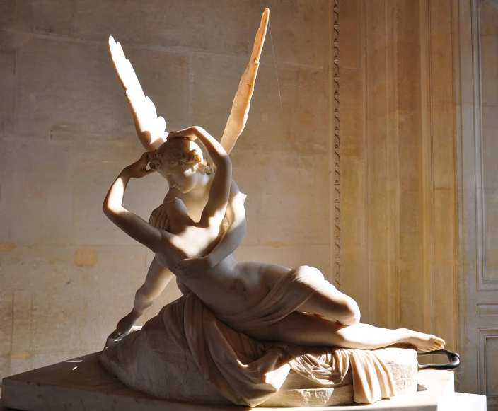 an antique style statue of a woman in the midst of an angel