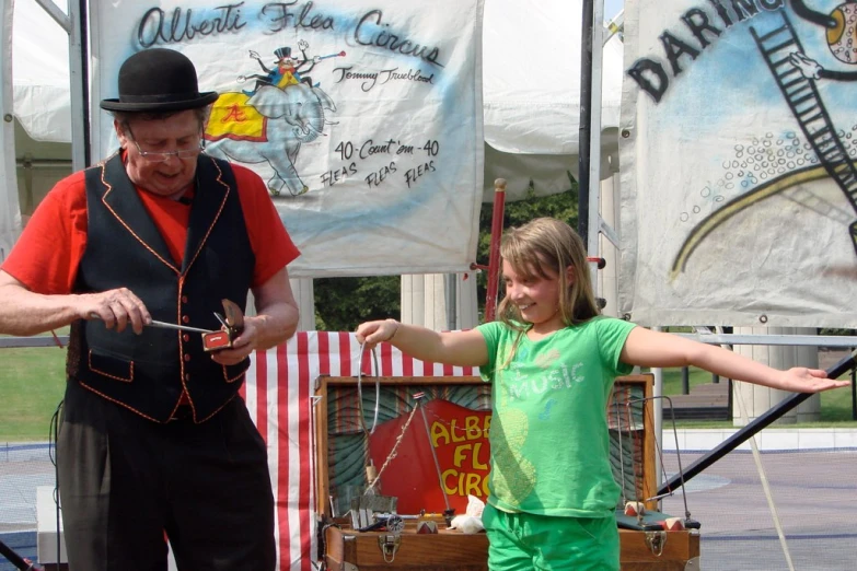 a little girl is playing a game on stage