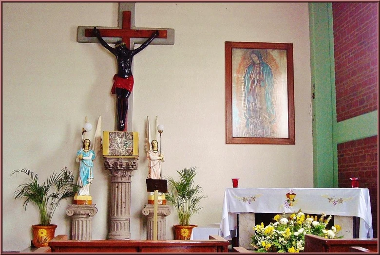 a cross above a church altar with flowers and candles