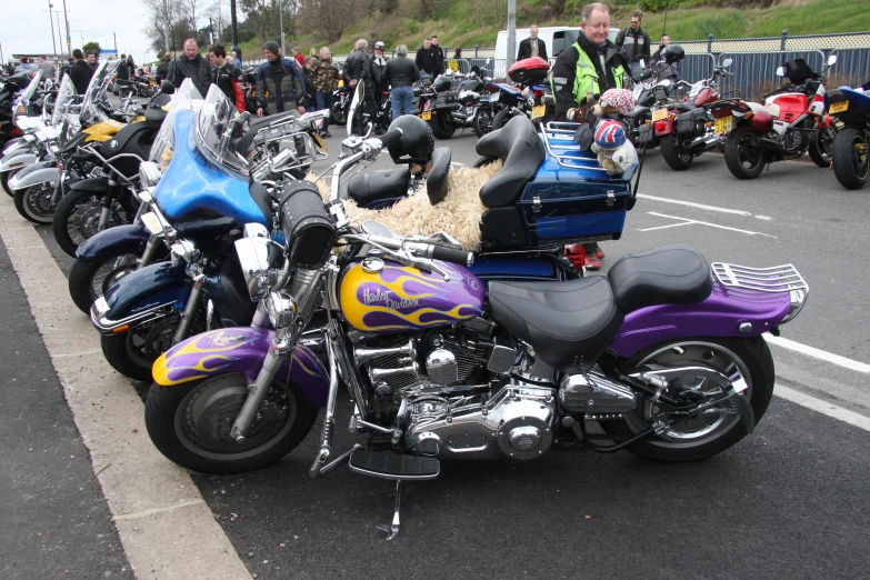 a long line of motorcycles in the parking lot