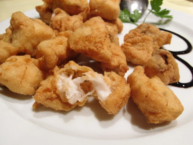 the food is fried and sitting on the plate