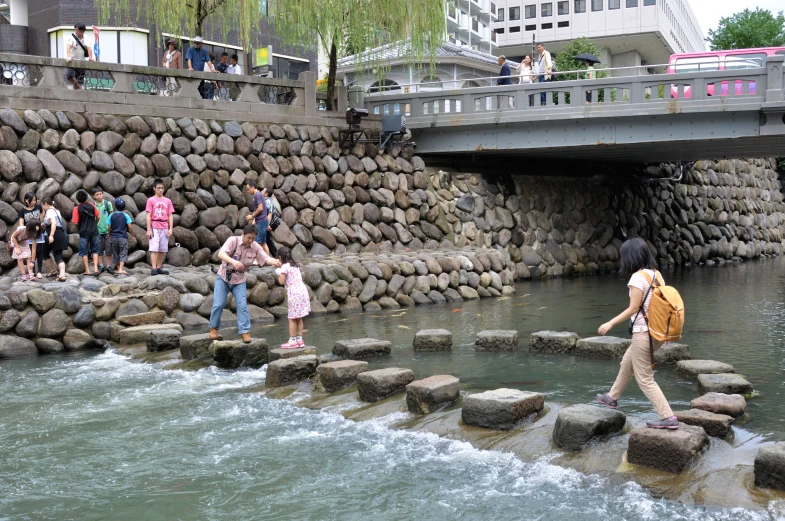 people cross the river to reach their next destination