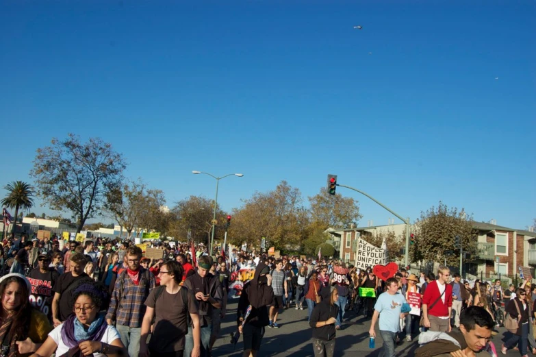 a large group of people are walking on the street