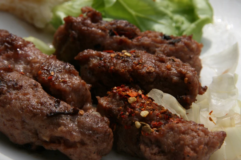 a close up of meat and vegetables on a plate