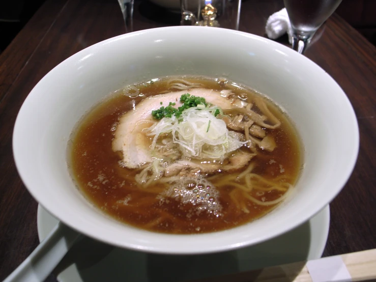 a close up of a bowl of soup with noodles