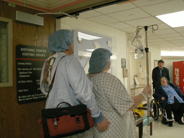 two woman in scrubs walking through the hospital