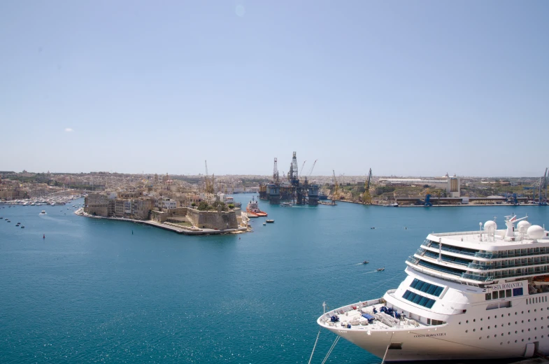 a cruise ship is anchored in the water with other boats