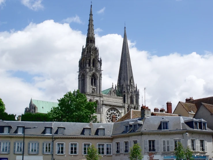 several tall gothic towers are seen from the distance