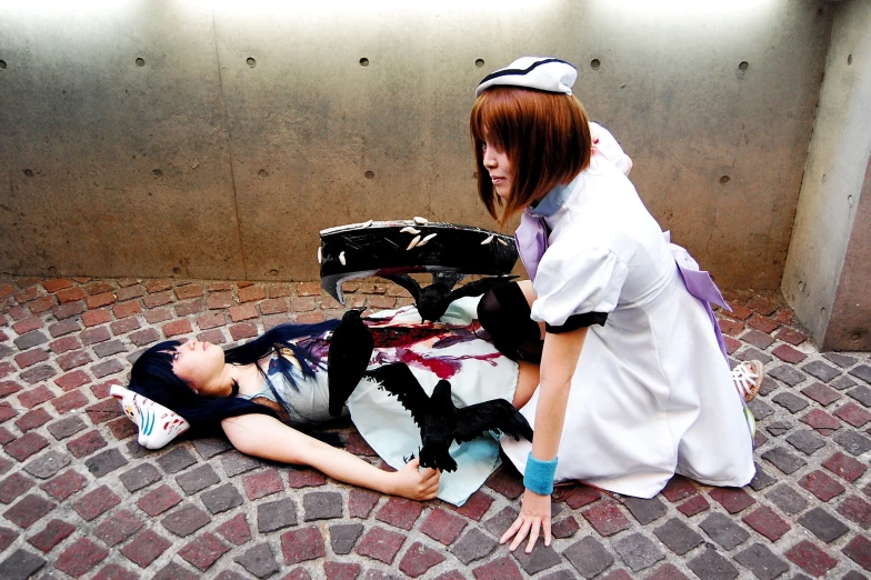 a woman in a white dress is on the ground next to a man with a helmet