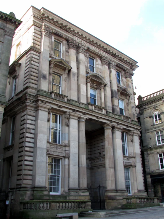 this is a very large tan building with columns and a tower