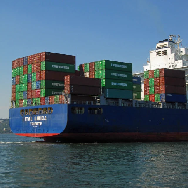 a large boat is carrying several giant containers